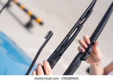 Faceless Woman Changing Car Windshield Wipers.