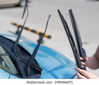 Faceless Woman Changing Car Windshield Wipers.