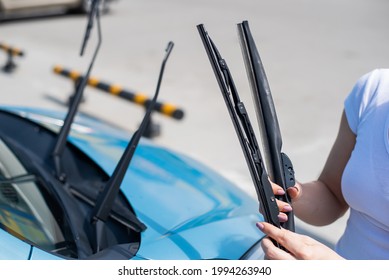 Faceless Woman Changing Car Windshield Wipers.