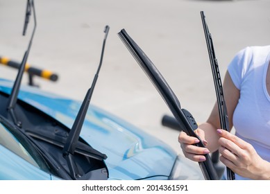 Faceless Woman Changing Car Windshield Wipers.