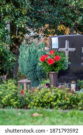 Facemask Lying On Grave Of Family Members With A Facemask During The Pandemic.