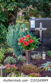 Facemask Lying On Grave Of Family Members With A Facemask During The Pandemic