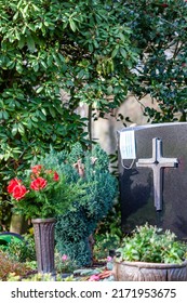 Facemask Lying On Grave Of Family Members With A Facemask During The Pandemic