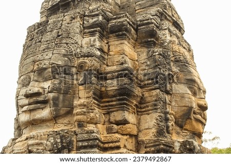 Faces of Bayon temple in Angkor Thom, Siemreap, Cambodia. Close up on the white background