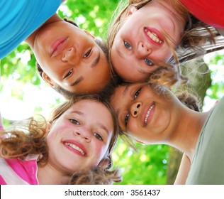 Faces Of Four Happy Young Girls Shot From Below