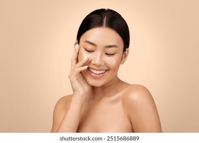 Facial Beauty. Happy Korean Young Woman Touching Her Face Enjoying Skin Perfection Posing Shirtless Over Light Gray Studio Background, Portrait Shot. Skincare Offer Advertisement - Powered by Shutterstock