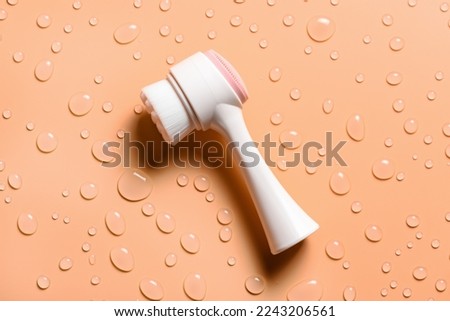 Facial brush and drops of liquid soap. Hygiene of the female face. Deep cleansing of the face.