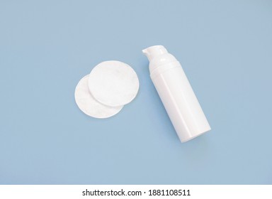 Facial Cleanser And Bottle With Face Cream And Cotton Pads On A Blue Background. Flat Lay, Top View, Copy Space