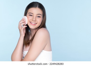 Facial cosmetic makeup concept. Portrait of young charming girl applying dry powder foundation. Beautiful girl smiling with perfect skin putting cosmetic makeup on her face. - Shutterstock ID 2249428283