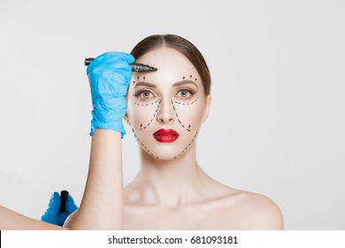 Facial Cosmetic Plastic Surgery. Doctor Surgeon Hand In Glove Draw Wrinkle Lines On Woman Face Isolated White Background. Sculpting Reshaping Wrinkles Fat Removal Cosmetic Filling Operation Concept