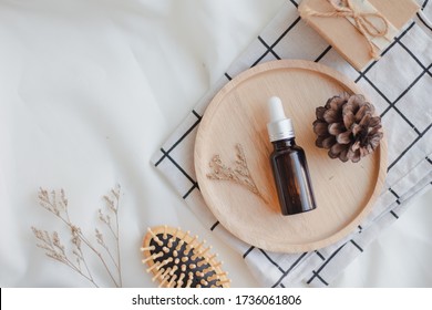 Facial Essential Oil Or Serum Packaging On Wood Tray On White Background. Beauty Cosmetic Product For Skincare Concept. Autumn And Winter. Top View. Flat Lay.