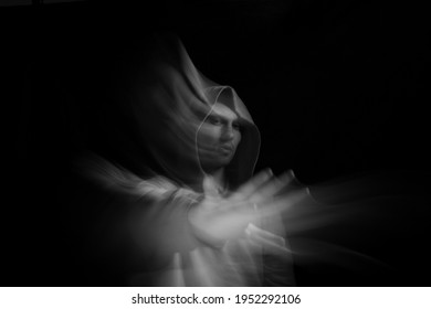 Facial face of a man in the dark. Art photography. Black-white art picture with a man. Portrait of man with blurred motion