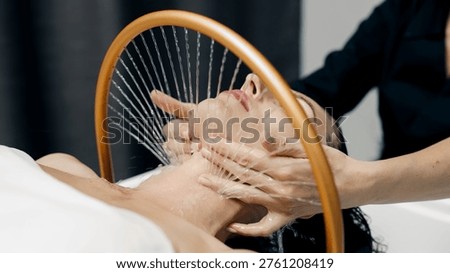Facial hydrotherapy device in spa generating smooth water flow, beauty and relaxation concept.
