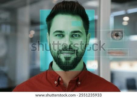 Facial and iris recognition system. Man undergoing biometric verification in office