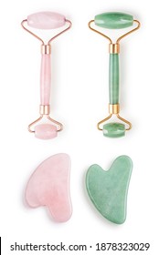 Facial jade massage rollers and gua sha massagers made from natural jade and rose quartz stone isolated on white background. 