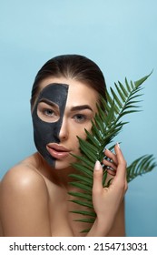 Facial Mask. Beautiful Young Woman With Black Mask Of Clay On Face .Skin Care .  Girl Beauty Model Face Care With Cosmetic Mask. Facial  Treatment.  Moisturizer Spa Mask