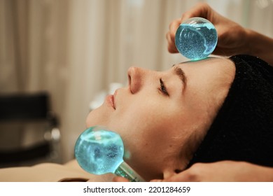 Facial massage with cold spheres. High quality photo - Shutterstock ID 2201284659