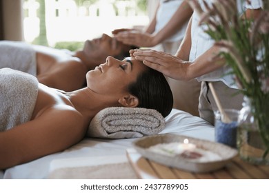 Facial massage, hands and couple in spa to relax on bed for luxury pamper treatment together in hotel. Beauty, head or zen woman with man at resort or salon for natural healing benefits or skincare - Powered by Shutterstock