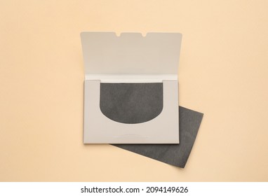 Facial oil blotting tissues on beige background, flat lay. Mattifying wipes