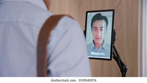 facial recognition concept - Asian businessman using face scanner to clock in work and check body temperature then unlock office door  - Powered by Shutterstock