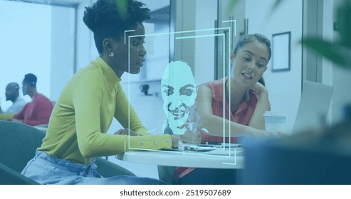 Facial recognition image over diverse colleagues discussing work at desk. Technology, innovation, collaboration, teamwork, diversity, office - Powered by Shutterstock