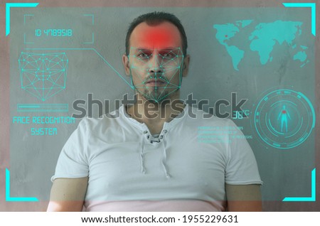 Facial recognition system, concept. Young man on the gray background, face recognition, individual human biometrics according to world standards, the ID passport