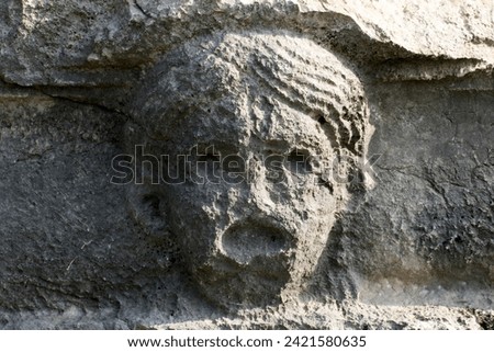 The facial relief carved on a rock to show the type of plays such as comedy, tragedy, etc. in the amphitheater of the  Castabala, which was an antique city dates back 2500 years. 