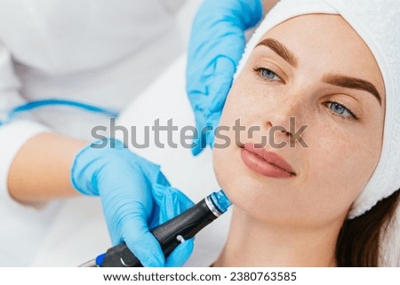 Facial skin care machine in spa clinic for anti-aging or acne treatment. The concept of aesthetic medicine, beauty tools, latest technologies in beauty industry. 