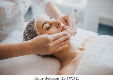 Facial skin treatment. Girl facial treatment. Facial skincare. Spa body care.Close up portrait of beautician's hands cleaning female face with cotton pads at - Shutterstock ID 2145771711