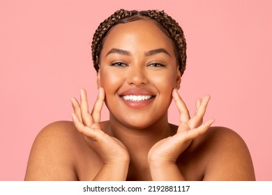 Facial Skincare. Attractive Black Woman Touching Face Moisturizing Smooth Skin Posing Smiling To Camera Over Pink Background In Studio. Beauty Routine And Pampering Concept - Powered by Shutterstock