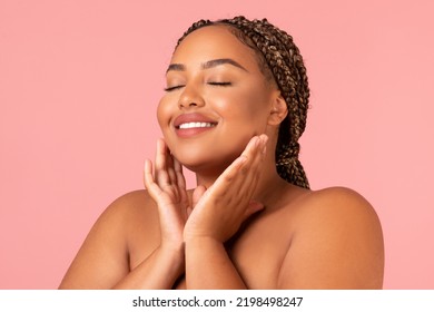 Facial Skincare. Portrait Of Happy Oversized Black Female Touching Face Caring For Perfect Smooth Skin Posing With Eyes Closed Over Pink Studio Background. Beauty And Selfcare Concept - Powered by Shutterstock