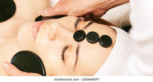 Facial Stone Massage. Hot Face Masseur. Girl At Salon With Doctor Hands.