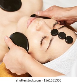 Facial Stone Massage. Hot Face Masseur. Girl At Salon With Doctor Hands.