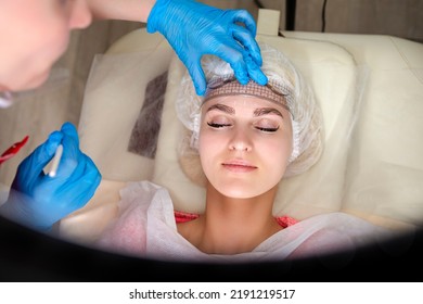 Facial Tattoo Markup With Transparent Facial Ruler On Eyebrows Of Young Caucasian Woman During A Process Of Permanent Make Up In Salon.Horizontal Shot