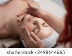 Facial treatment. Beauty skin, skincare massage in a beauty clinic. Facial lifting massage in SPA salon. A cosmetologist girl does a facial massage. Cosmetic procedure. Beauty spa and cosmetology.