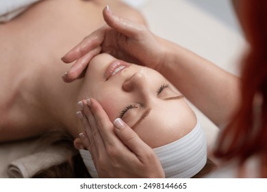 Facial treatment. Beauty skin, skincare massage in a beauty clinic. Facial lifting massage in SPA salon. A cosmetologist girl does a facial massage. Cosmetic procedure. Beauty spa and cosmetology. - Powered by Shutterstock