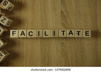 Facilitate Word From Wooden Blocks On Desk