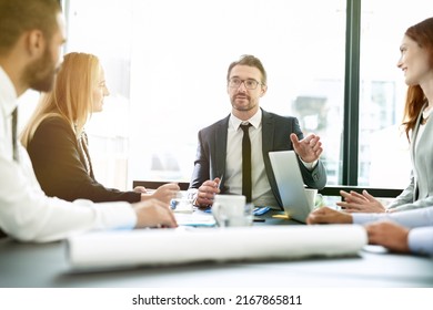 Facilitating Their Meeting With Clear Direction. Shot Of A Team Of Executives Having A Formal Meeting In A Boardroom.