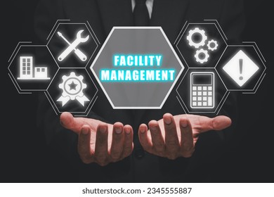 Facility management concept, Business person hand holding facility management icon on virtual screen.