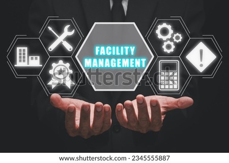 Facility management concept, Business person hand holding facility management icon on virtual screen.