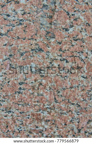 Facing material red granite texture. Natural stone granite background texture. Bright hard red granitic rock texture. Red granite granitic stone background texture. Red granite untreated surface.