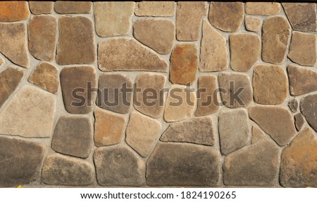 Facing stone brick wall texture background. Modern slate outdoor decorative rocks. Aged grungy coarse stonework city. Tile textured of general layout of stones masonry with mixed block various shapes.