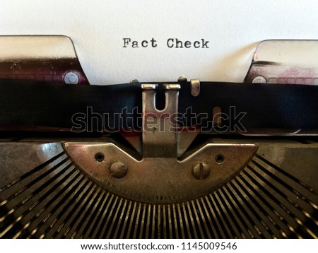 Fact Check, heading title typewritten in black ink on white paper on vintage retro old fashioned obsolete typewriter machine