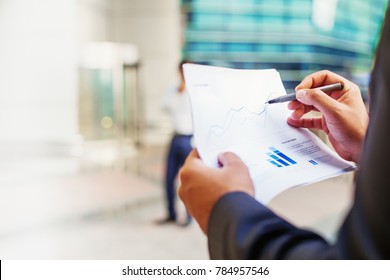 Fact Sheet Of A Mutual Fund With Graphs In A Hand Of Businessman