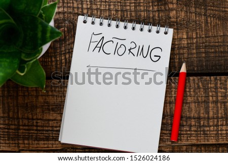 Factoring text written in a notebook. View from above
