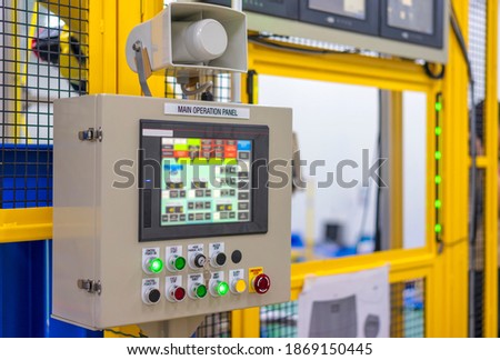 Factory 4.0 concept : View of operation panel and product inspection monitoring display on fence of manufacturing machine