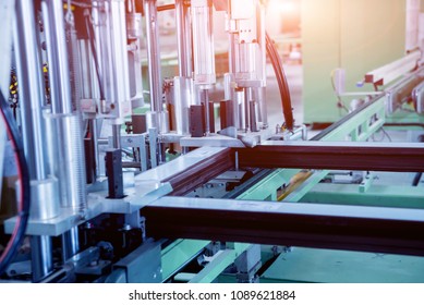 Factory for aluminum and PVC windows and doors production. Details industrial equipment. Background - Shutterstock ID 1089621884