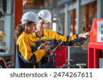 Factory apprenticeship. Man mentor teaching Female employees trainee operating machine looking monitors and check Production process machinery. foreman explaining woman engineer control machine