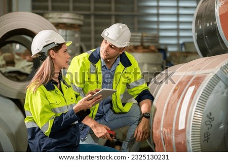 Factory apprenticeship. Man mentor teaching Female employees trainee operating machine looking monitors and check Production process machinery. foreman explaining woman engineer control machine
