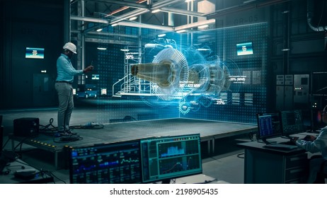 Factory: Black Engineer Holds Tablet Computer, Designes Engine in Augmented Reality App. Industry 4.0 Concept: Research, Development, Visualization, Digitalization of Green Electric Energy - Shutterstock ID 2198905435